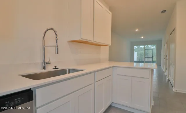 a kitchen with a sink and cabinets