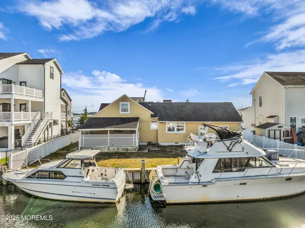 a view of a house with pool and chairs