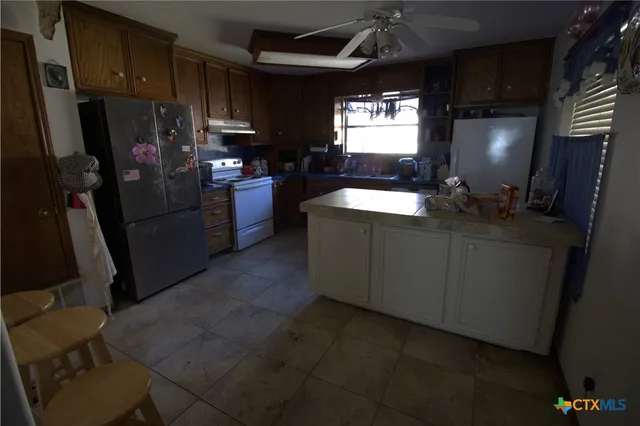 a kitchen with refrigerator and window