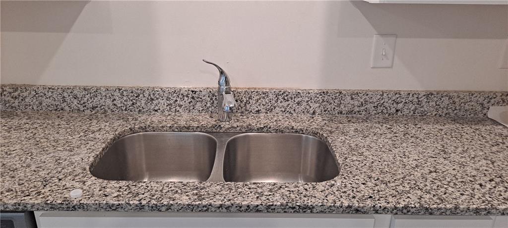 1683 Vernon Boulevard Decatur, GA 30035 - Photo 5 of 14 a bathroom with a granite countertop sink and a mirror