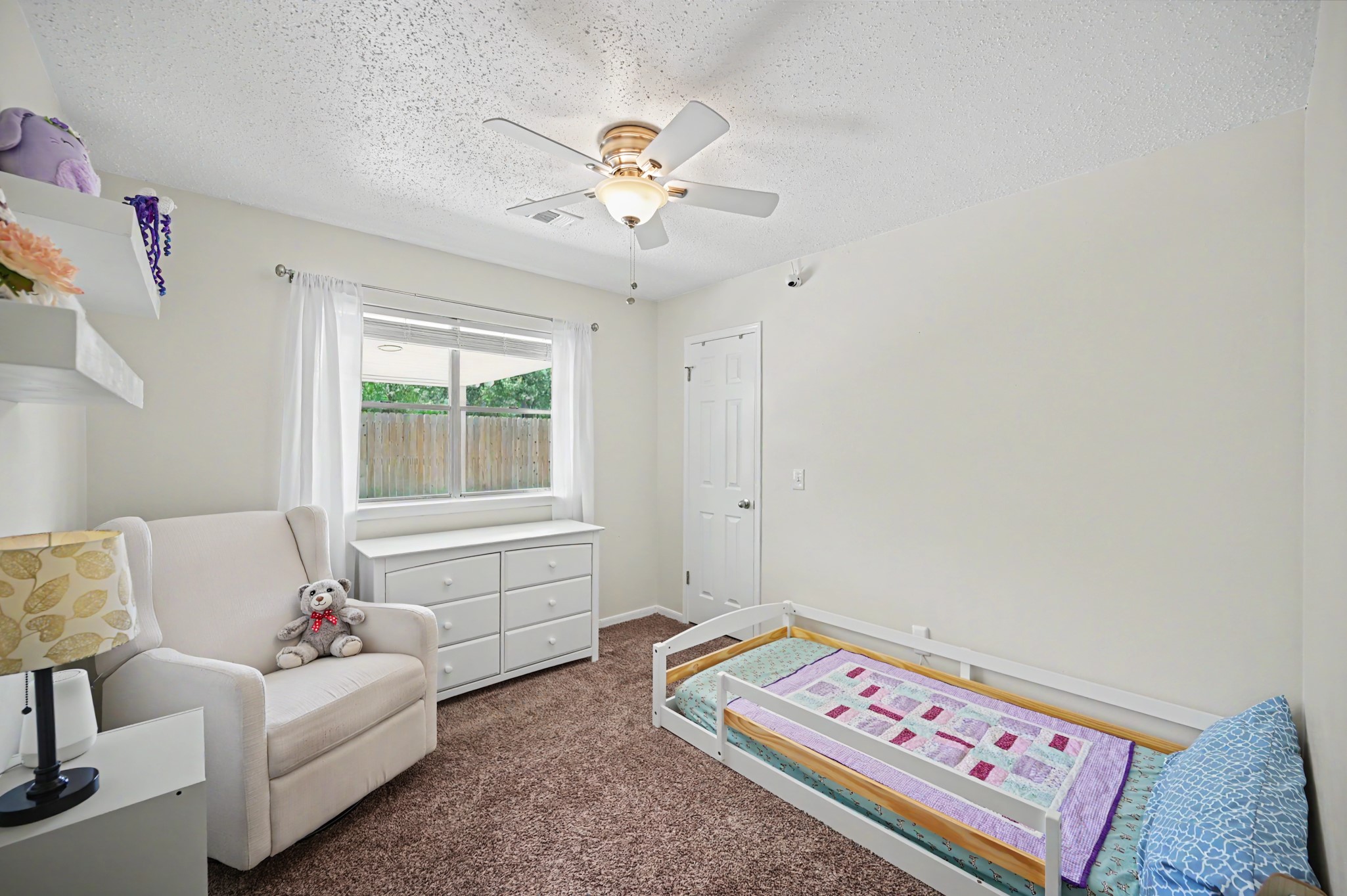 17019 Fordingbridge Court Spring, TX 77379 - Photo 17 of 26 Spacious secondary bedroom #1 offers a comfortable and versatile layout with plush carpeting, ceiling fan, and a large window overlooking the backyard
