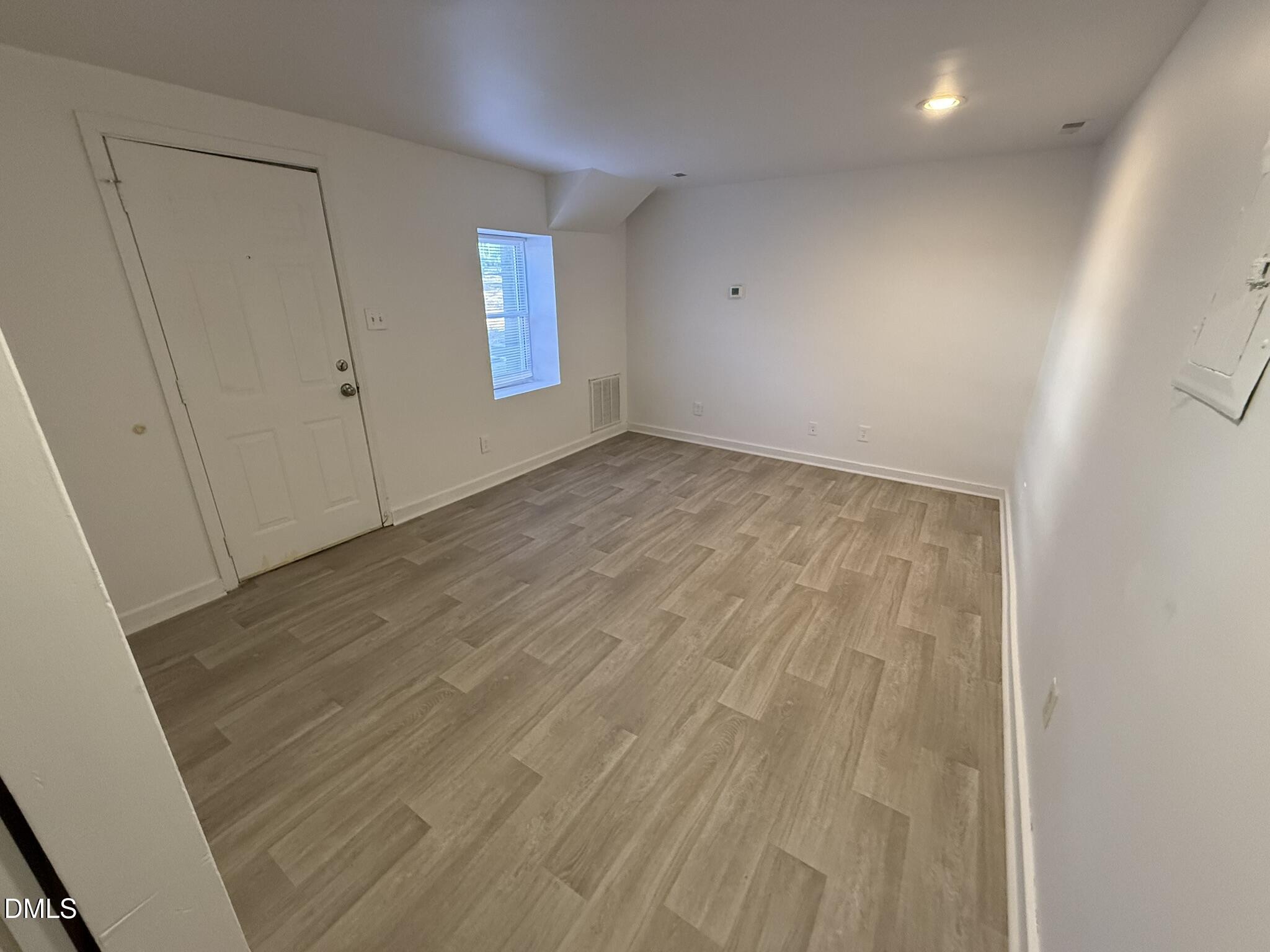 1113 Gurley Street, Unit B Durham, NC 27701 - Photo 4 of 10 an empty room with windows