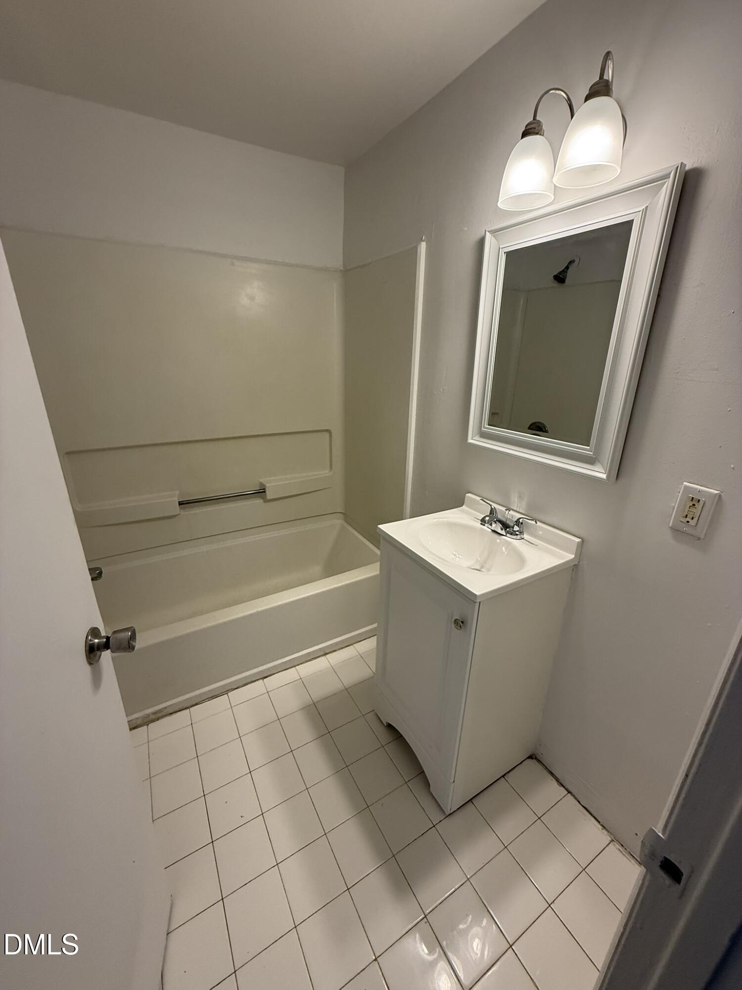 1113 Gurley Street, Unit B Durham, NC 27701 - Photo 6 of 10 a bathroom with a sink vanity and mirror