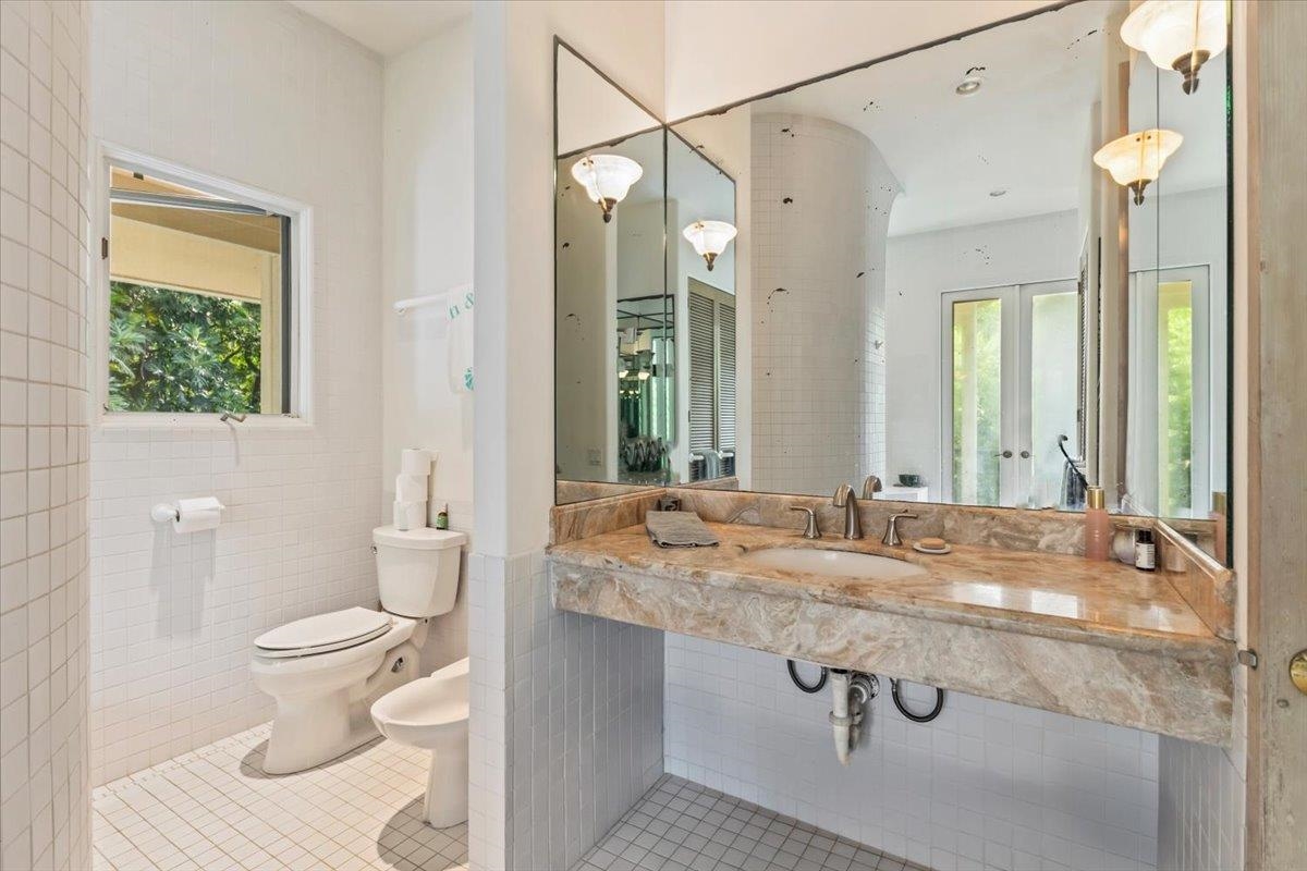 6900 Hana Highway Hana, HI 96713 - Photo 16 of 50 a bathroom with a granite countertop sink a toilet and a mirror