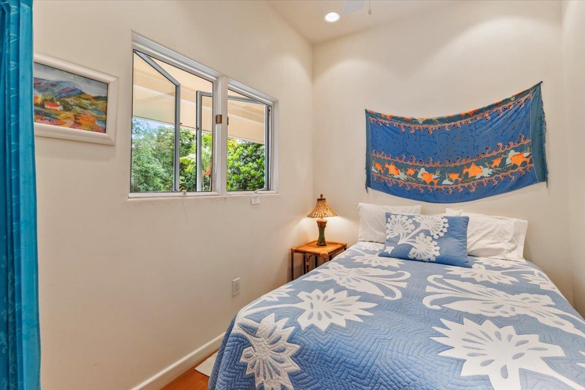 6900 Hana Highway Hana, HI 96713 - Photo 35 of 50 a bedroom with a bed and a painting on the wall