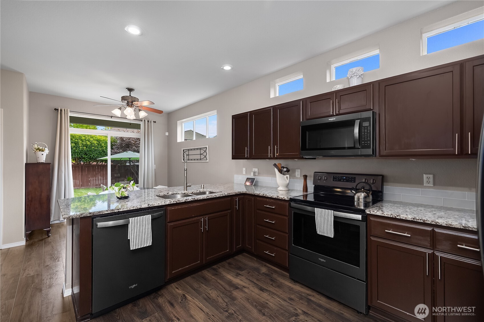 3526 Becket Street Northeast Lacey, WA 98516 - Photo 11 of 32 a kitchen with stainless steel appliances granite countertop wooden cabinets and a stove top oven