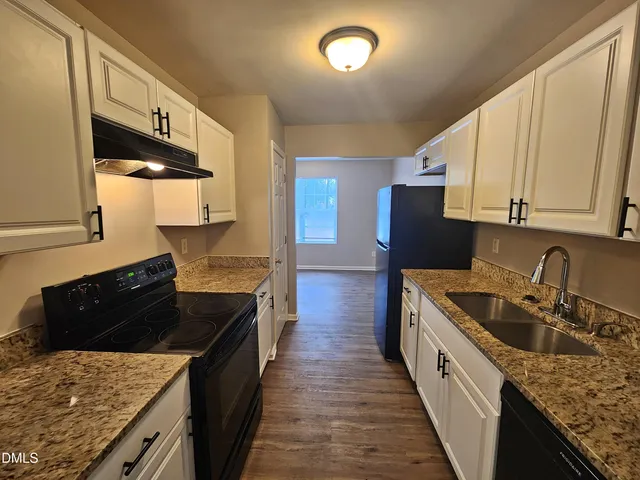 a kitchen with stainless steel appliances a refrigerator and a stove