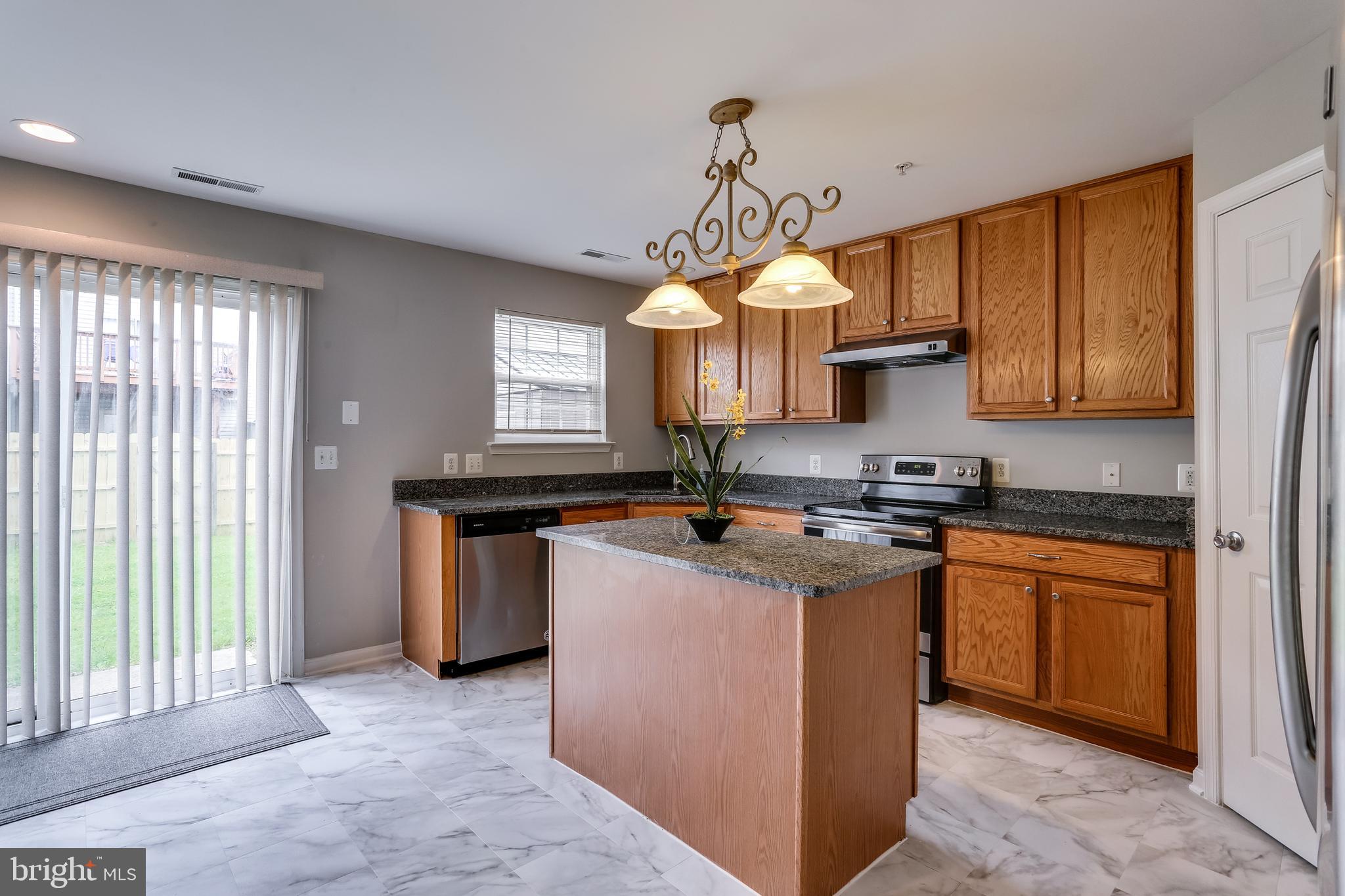 673 Hunting Fields Road Baltimore, MD 21220 - Photo 10 of 31 a kitchen with stainless steel appliances granite countertop a sink a stove and a refrigerator