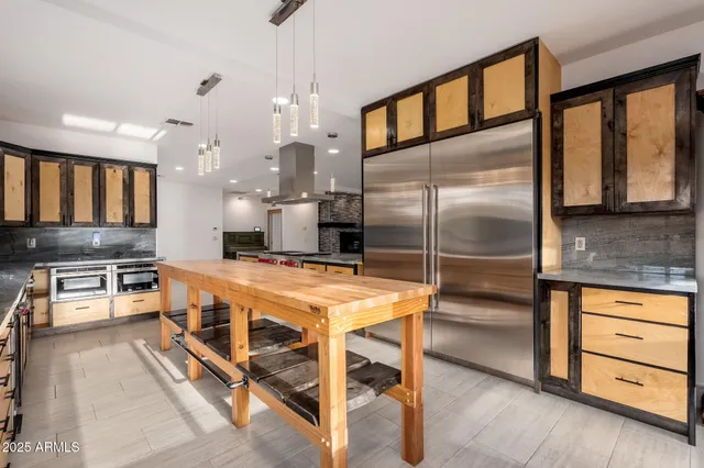 an empty room with windows and ceiling fan