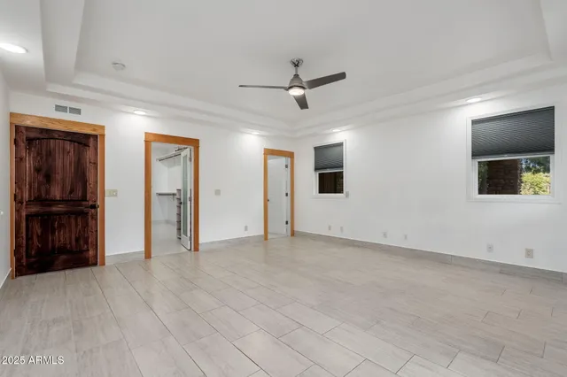 a spacious bathroom with a granite countertop sink mirror and shower