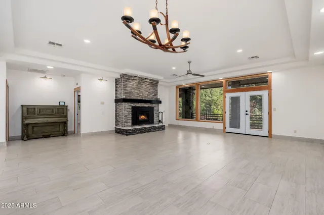 an empty room with windows and a fireplace