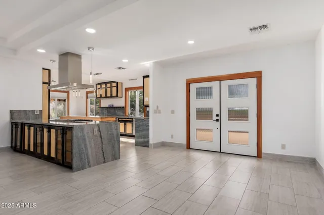 a kitchen with stainless steel appliances granite countertop a stove and a sink