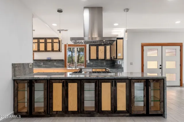 a kitchen with a stove and a kitchen island
