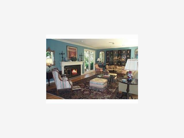 47 Ralston Road Atherton, CA 94027 - Photo 2 of 5 a living room with furniture a fireplace and a flat screen tv