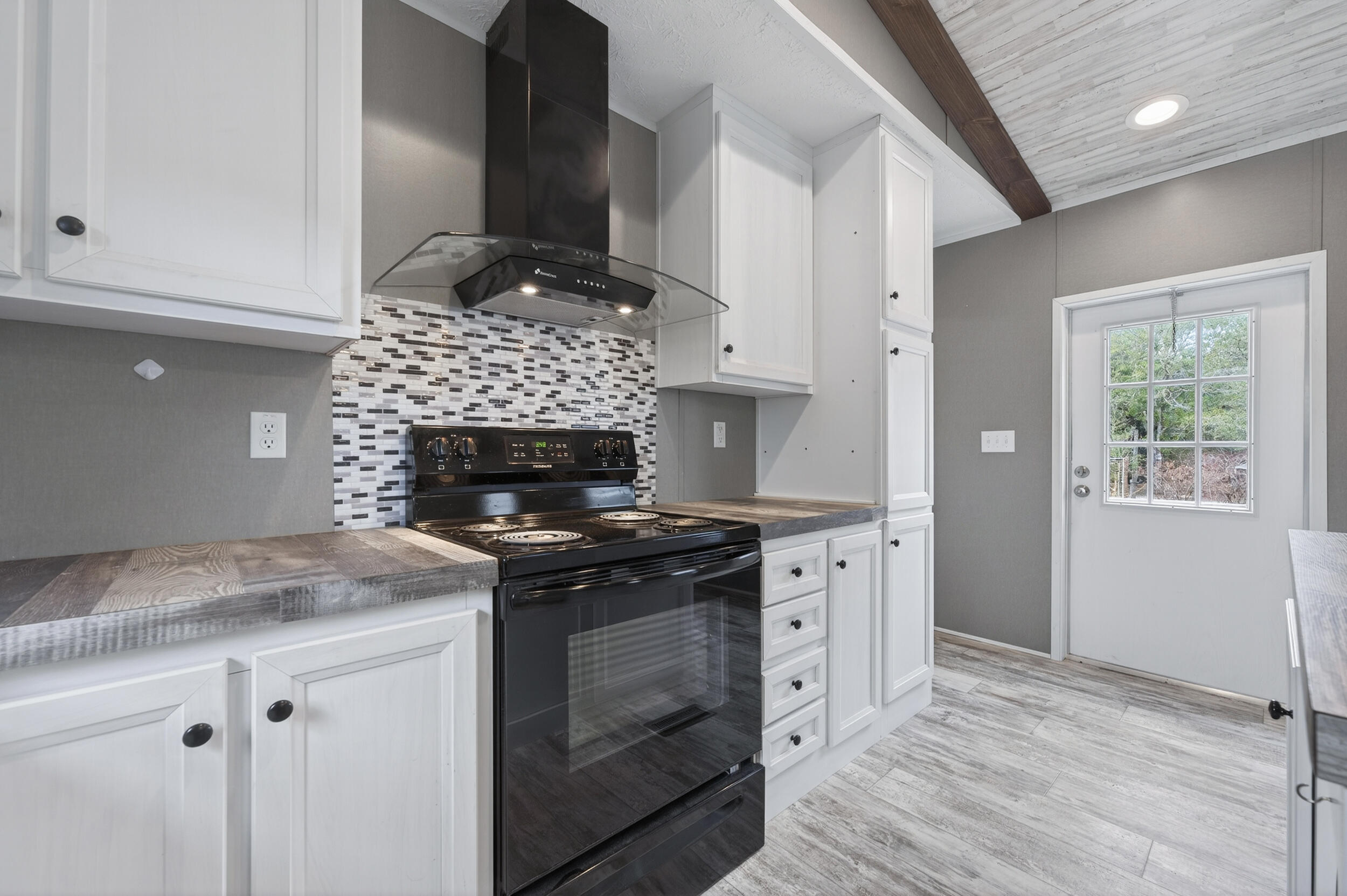 4528 Bryant Bridge Cutoff Road Holt, FL 32564 - Photo 11 of 63 a kitchen with stainless steel appliances granite countertop a stove and a refrigerator
