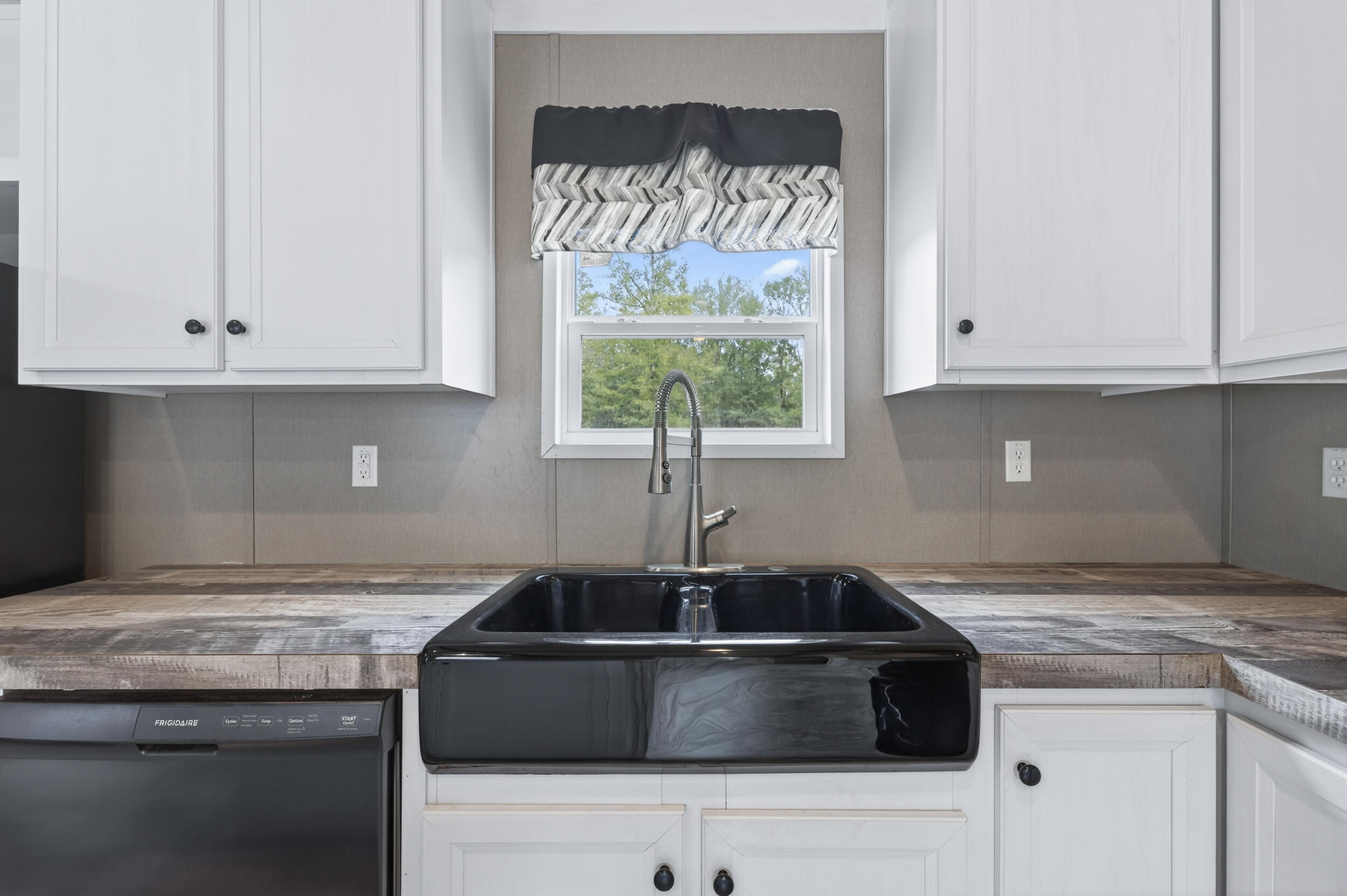 4528 Bryant Bridge Cutoff Road Holt, FL 32564 - Photo 13 of 63 a kitchen with granite countertop a sink stainless steel appliances white cabinets and a window