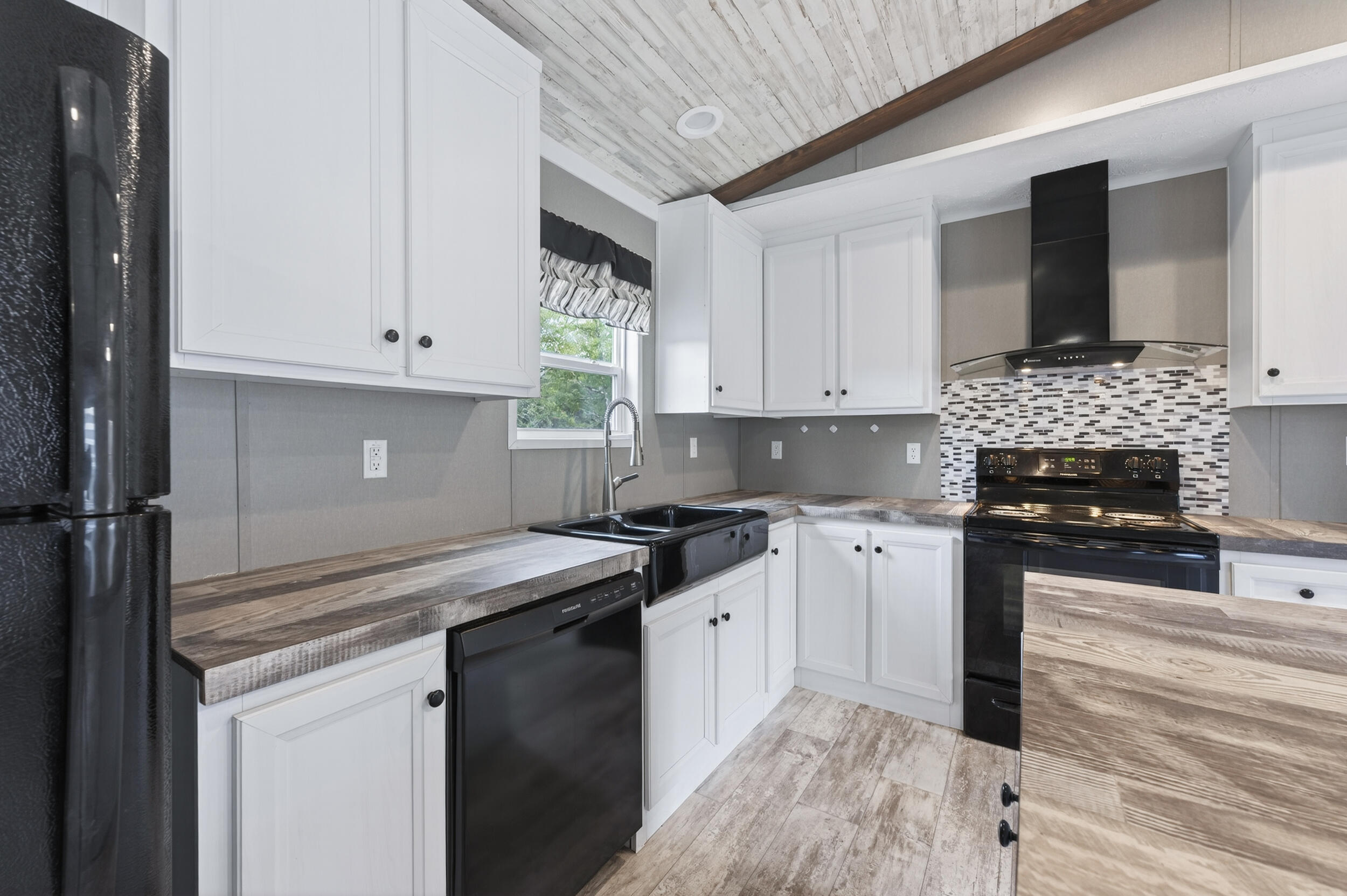 4528 Bryant Bridge Cutoff Road Holt, FL 32564 - Photo 14 of 63 a kitchen with stainless steel appliances granite countertop a stove a sink and a microwave