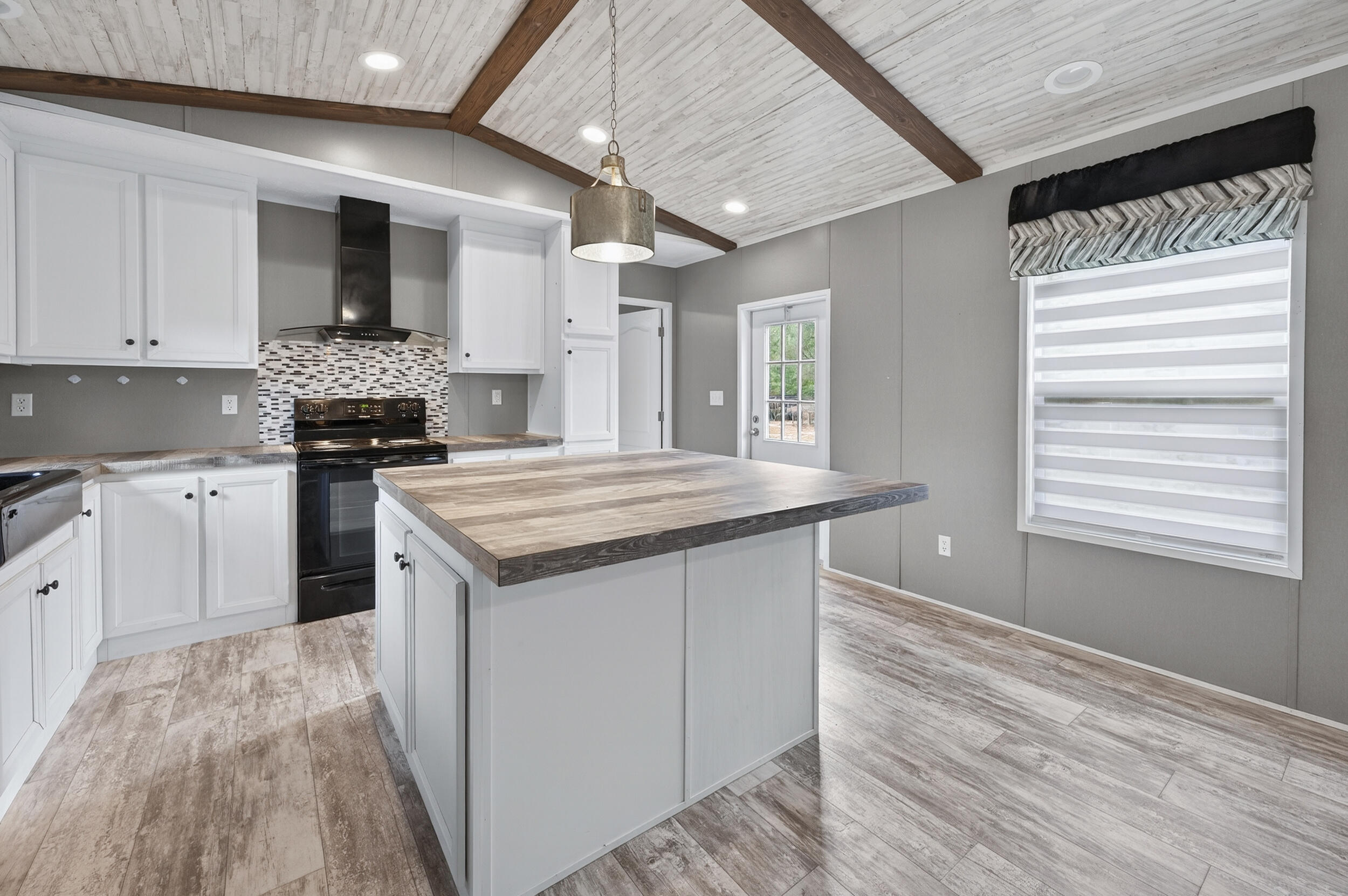 4528 Bryant Bridge Cutoff Road Holt, FL 32564 - Photo 15 of 63 a kitchen with a sink stove and cabinets