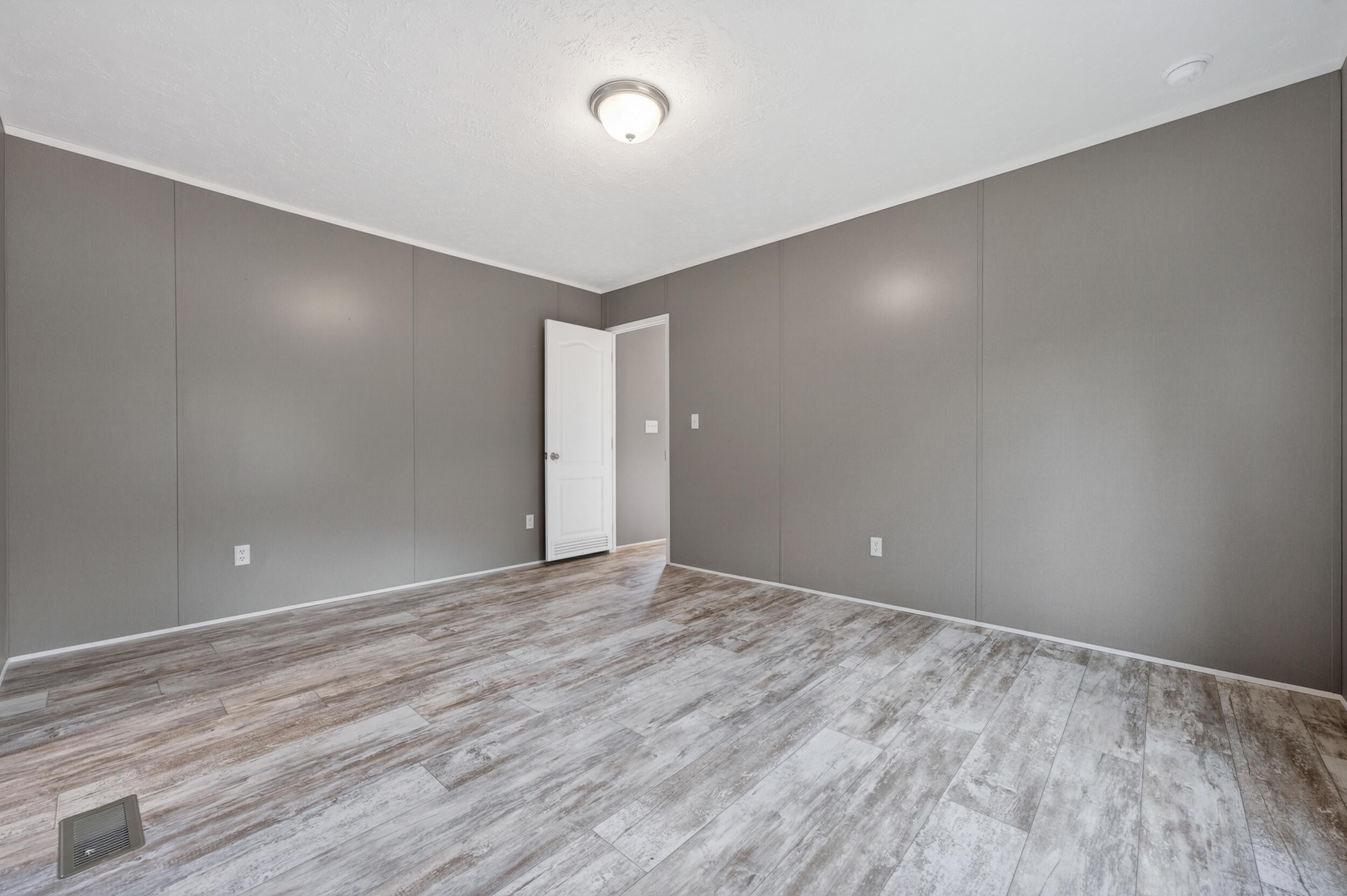 4528 Bryant Bridge Cutoff Road Holt, FL 32564 - Photo 19 of 63 a view of an empty room with wooden floor and closet