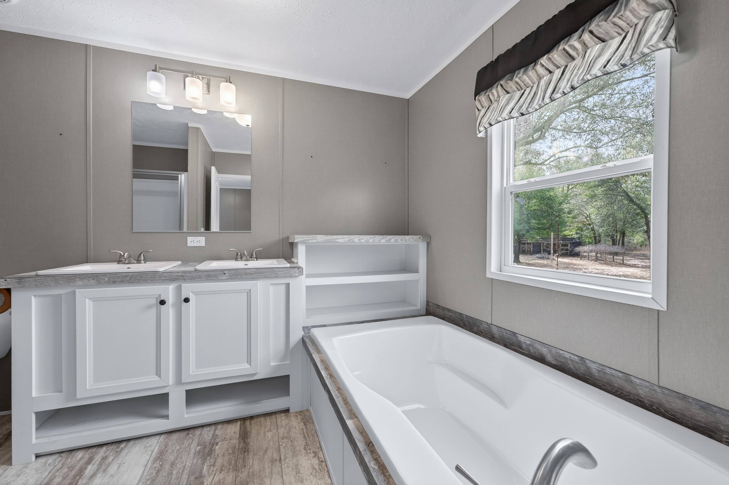4528 Bryant Bridge Cutoff Road Holt, FL 32564 - Photo 21 of 63 a bathroom with a tub sink and mirror