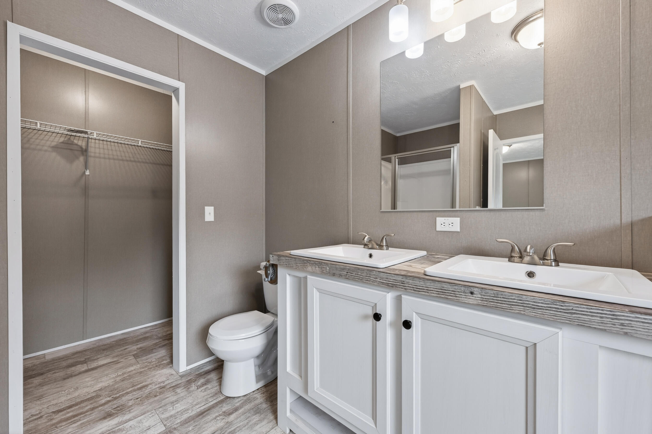 4528 Bryant Bridge Cutoff Road Holt, FL 32564 - Photo 22 of 63 a bathroom with a granite countertop sink a toilet and a mirror