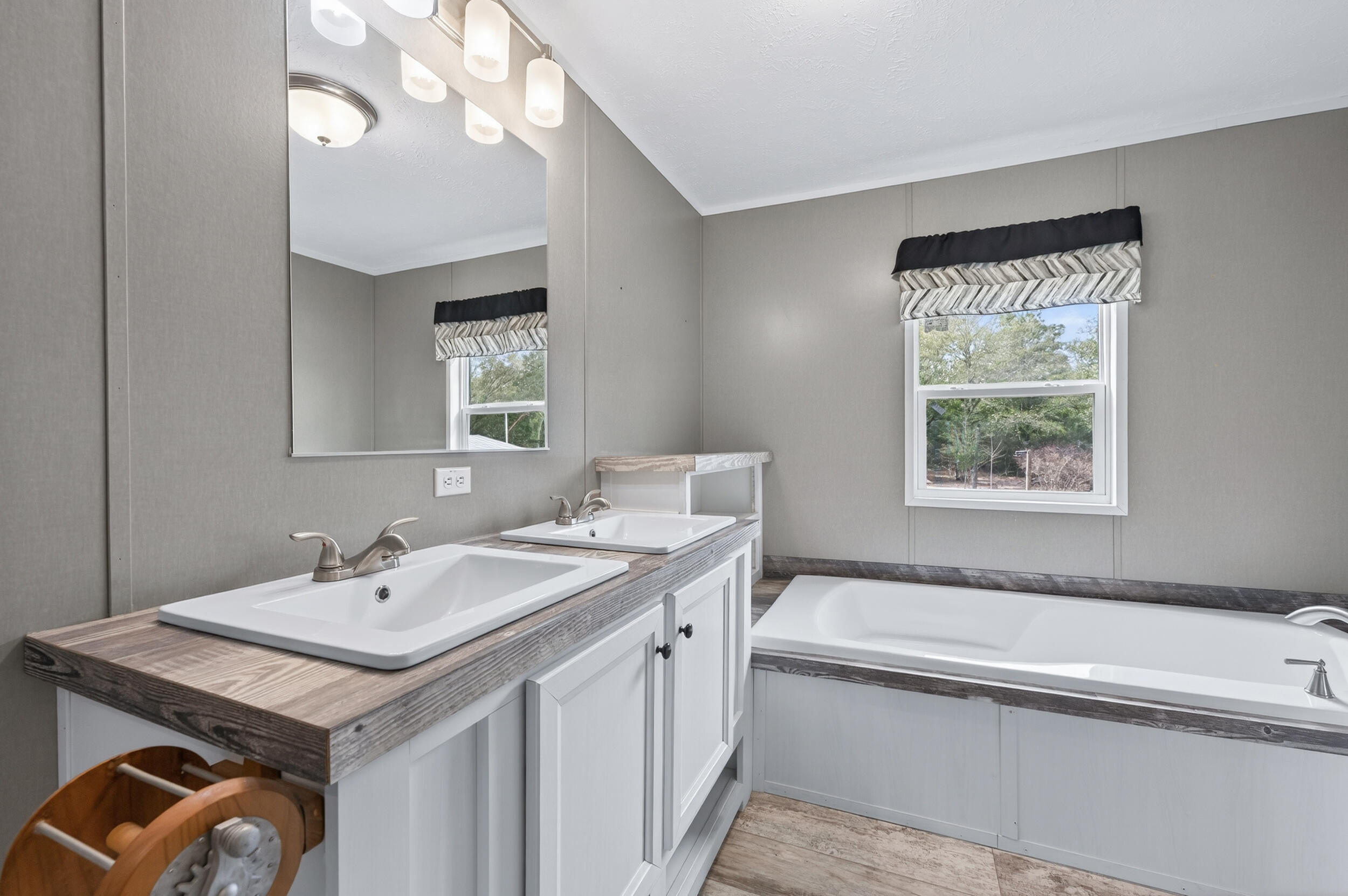 4528 Bryant Bridge Cutoff Road Holt, FL 32564 - Photo 26 of 63 a bathroom with a granite countertop sink a large mirror and a bathtub