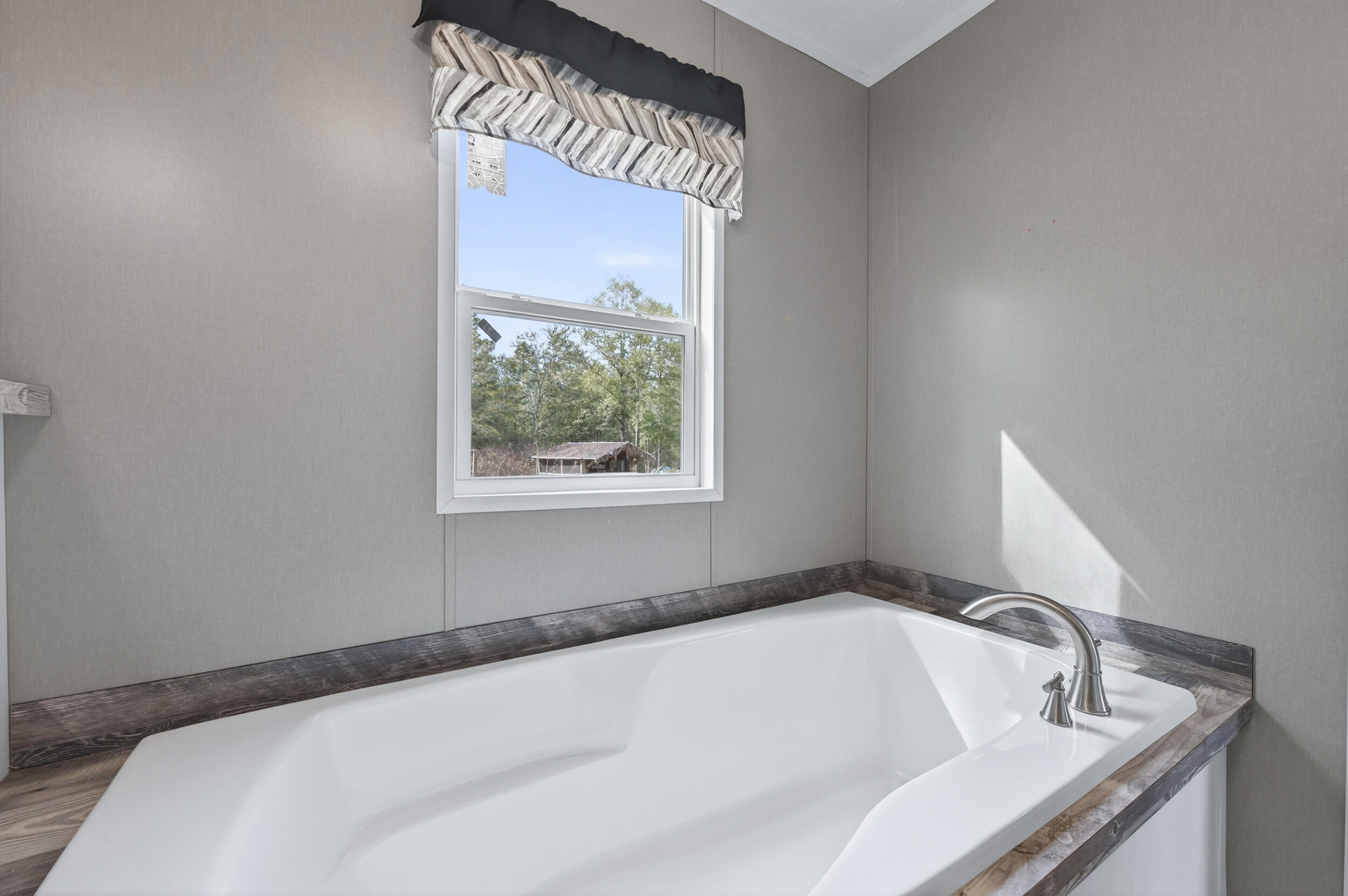 4528 Bryant Bridge Cutoff Road Holt, FL 32564 - Photo 28 of 63 a white bath tub sitting in a bathroom