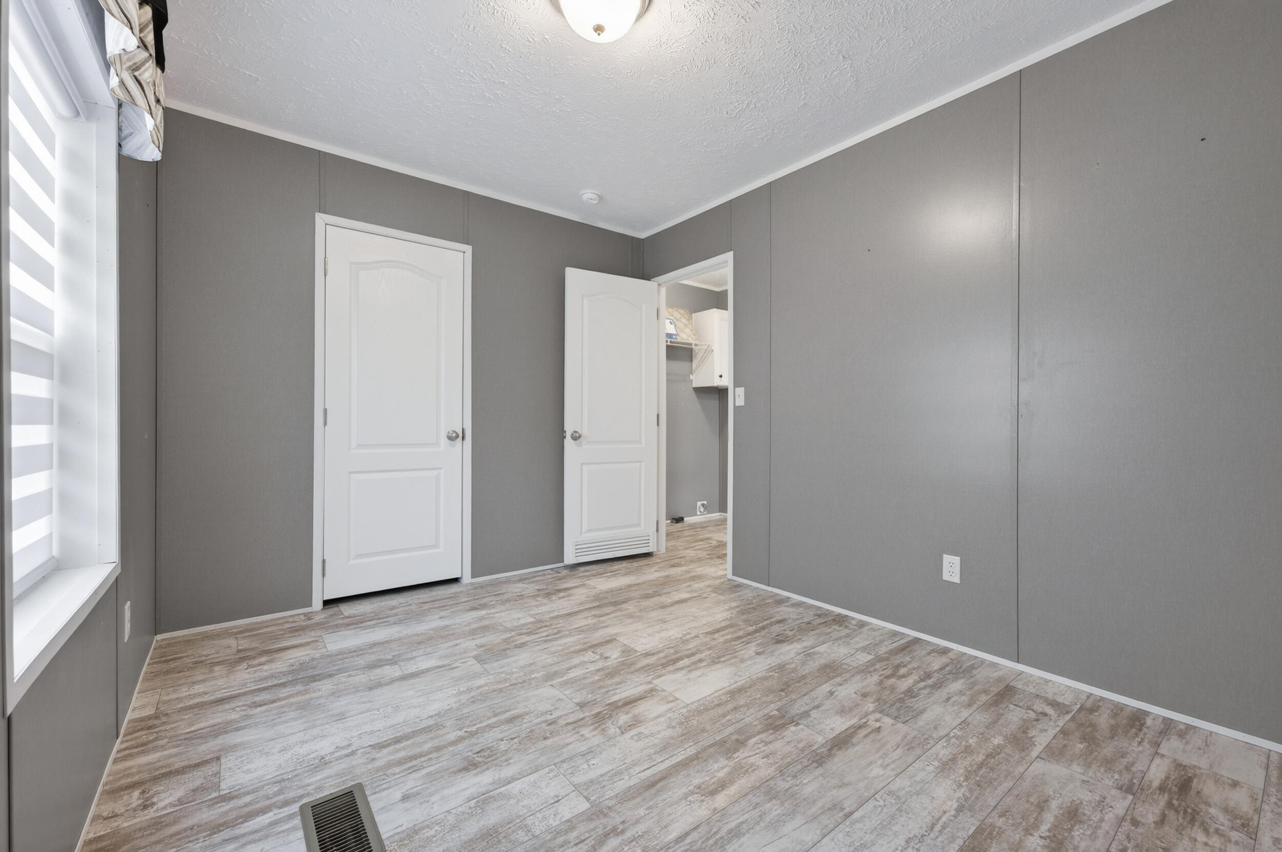 4528 Bryant Bridge Cutoff Road Holt, FL 32564 - Photo 31 of 63 a view of an empty room with wooden floor