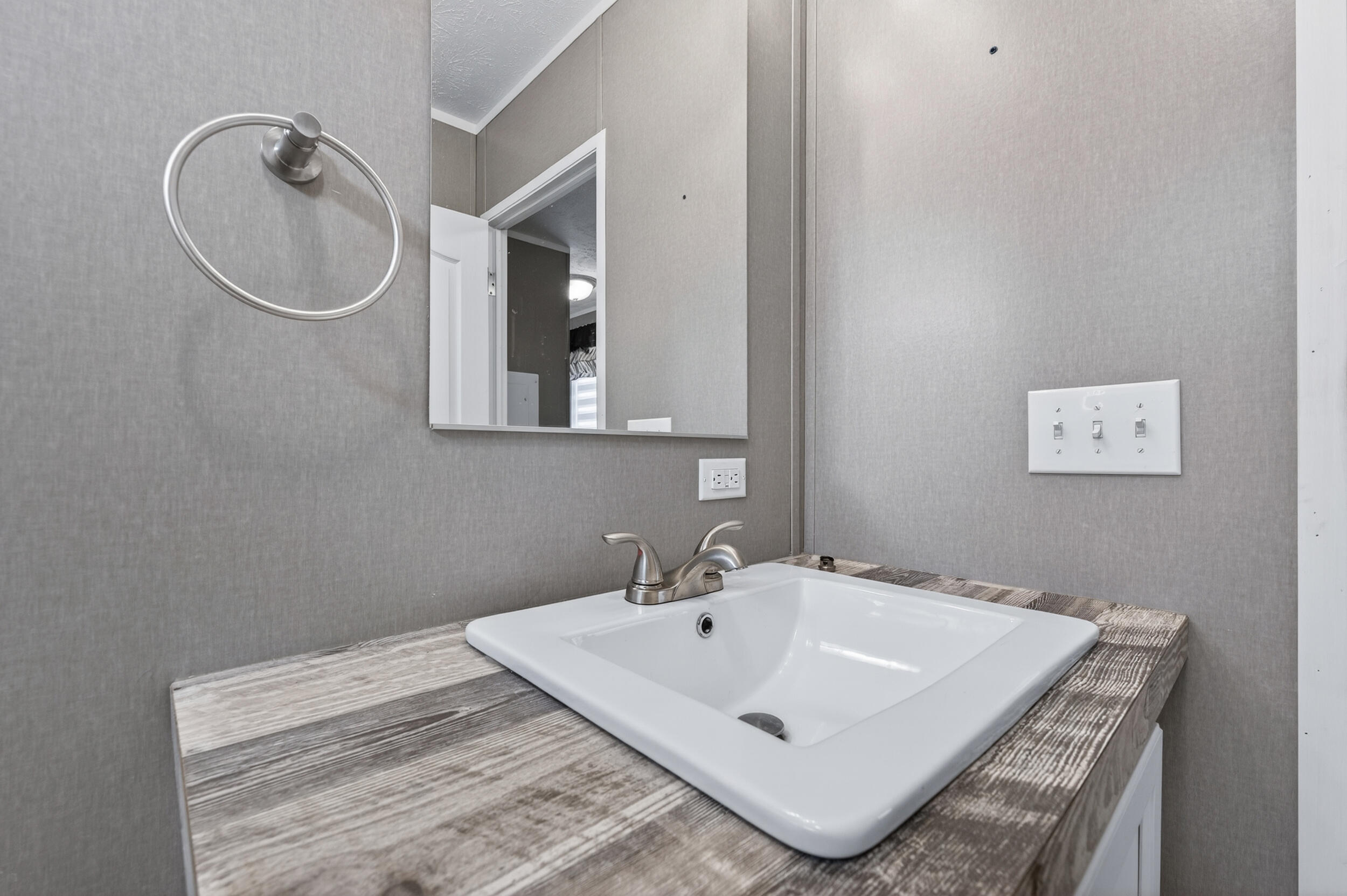 4528 Bryant Bridge Cutoff Road Holt, FL 32564 - Photo 38 of 63 a white bath tub sitting next to a bathroom sink