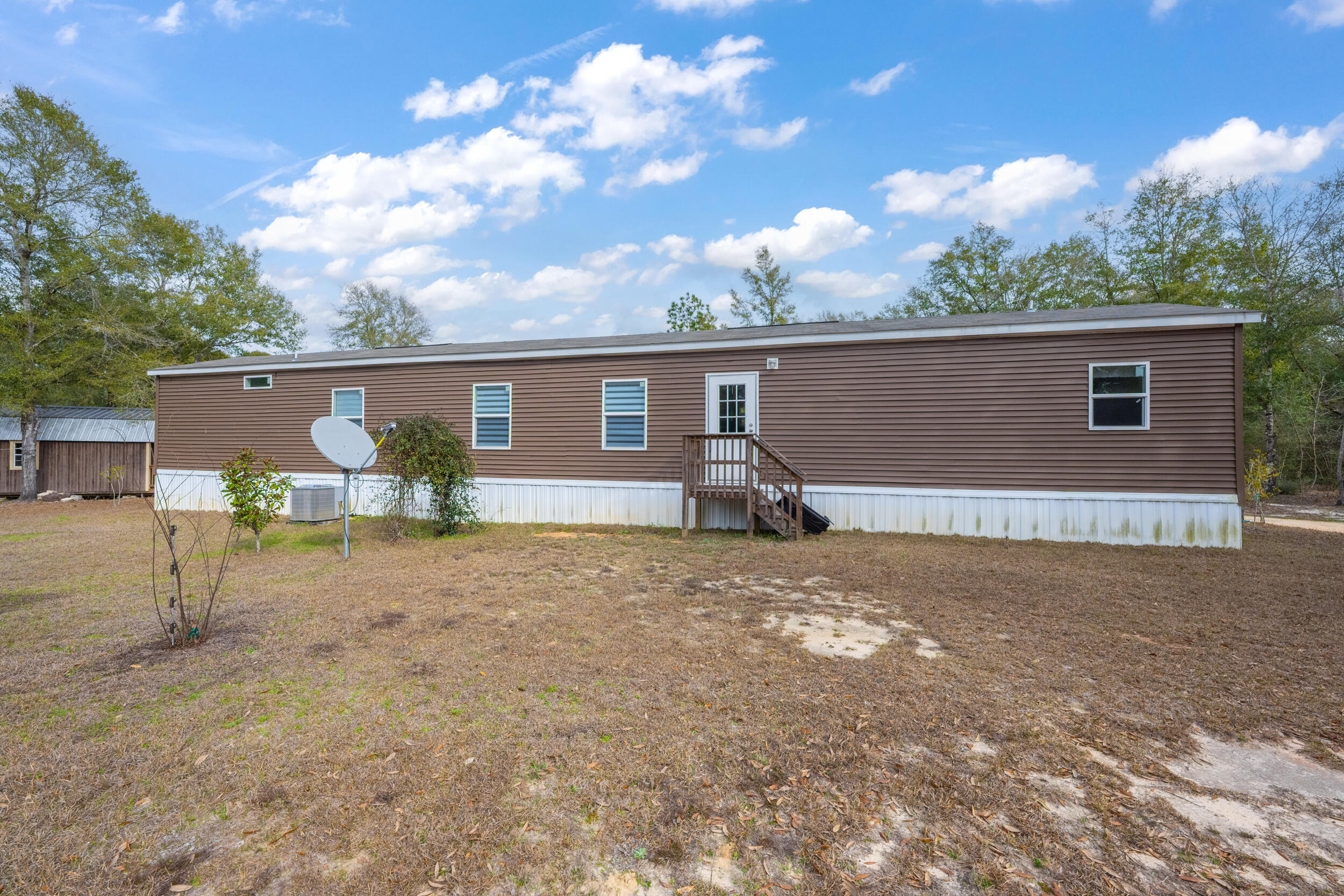 4528 Bryant Bridge Cutoff Road Holt, FL 32564 - Photo 39 of 63 a view of a house with backyard and a tree
