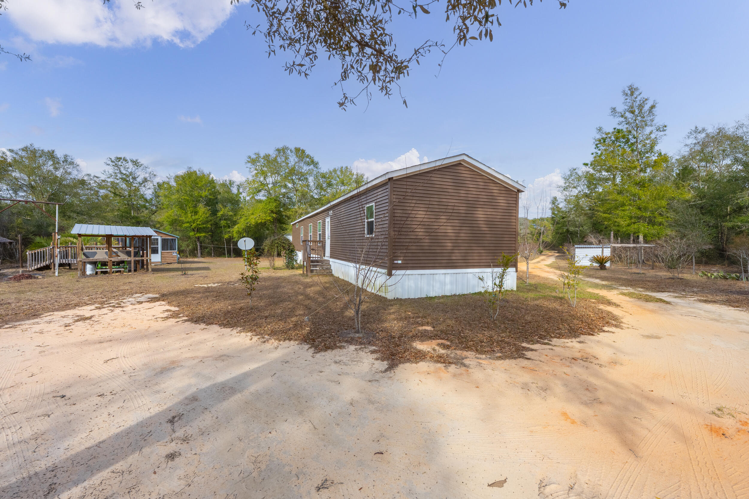 4528 Bryant Bridge Cutoff Road Holt, FL 32564 - Photo 40 of 63 a front view of a house with a yard and garage