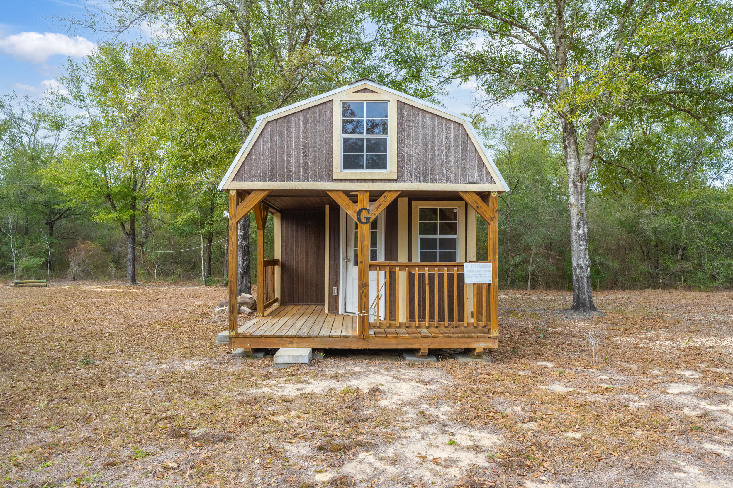 4528 Bryant Bridge Cutoff Road Holt, FL 32564 - Photo 44 of 63 a front view of a house with a yard