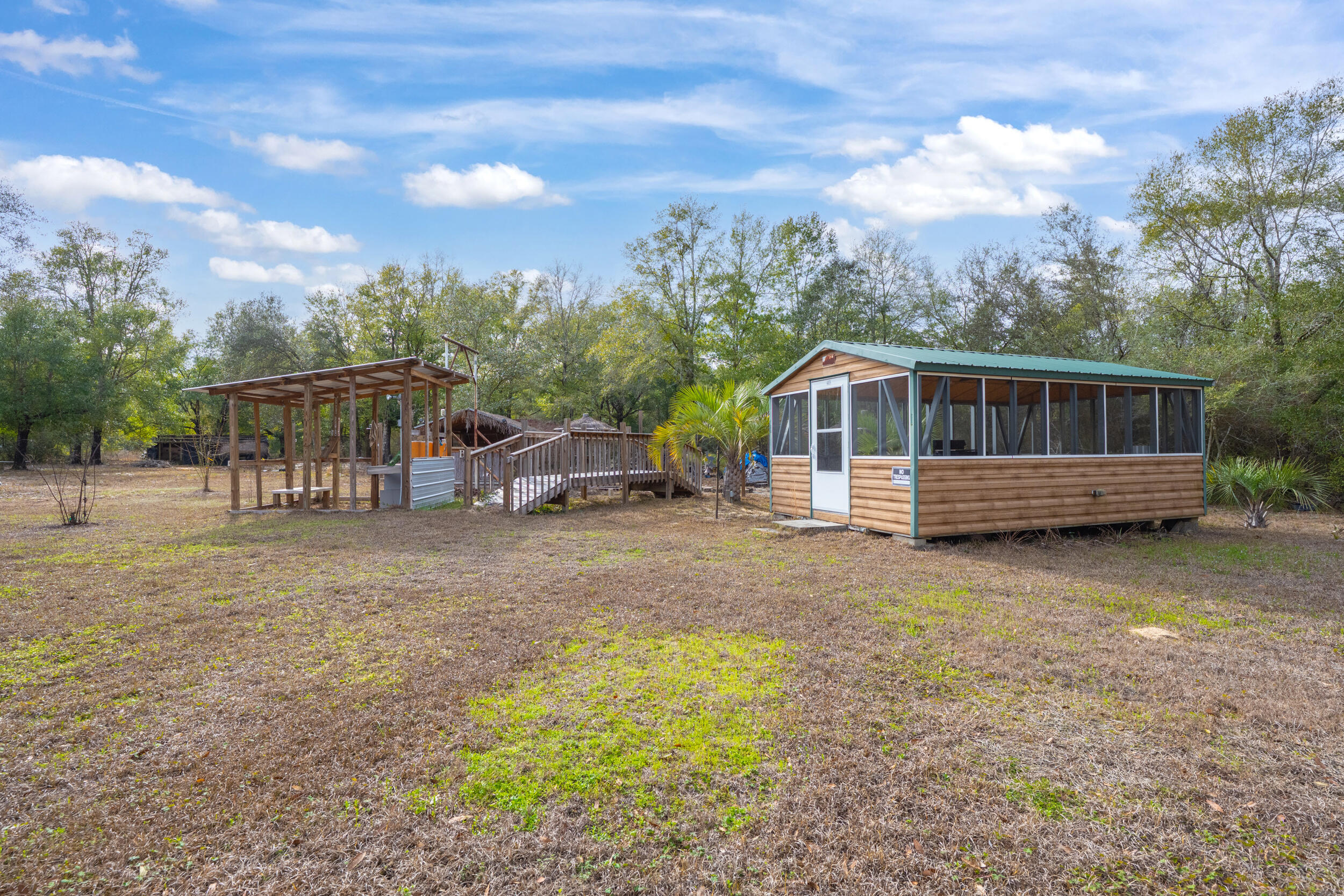 4528 Bryant Bridge Cutoff Road Holt, FL 32564 - Photo 50 of 63 a view of a house with a yard