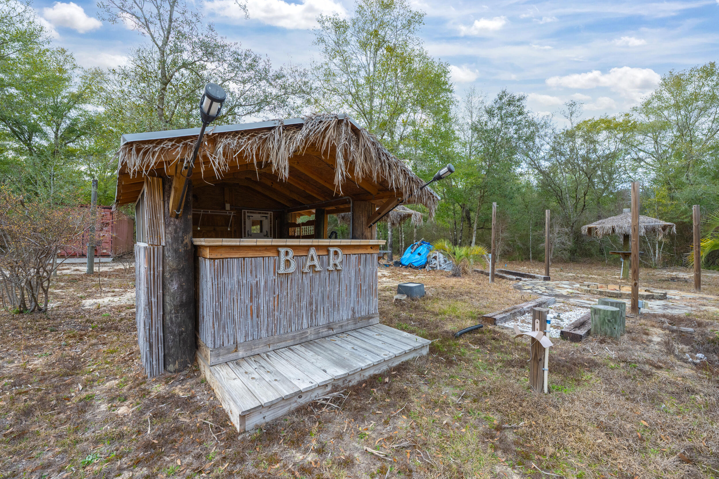 4528 Bryant Bridge Cutoff Road Holt, FL 32564 - Photo 54 of 63 a view of a backyard with a swing