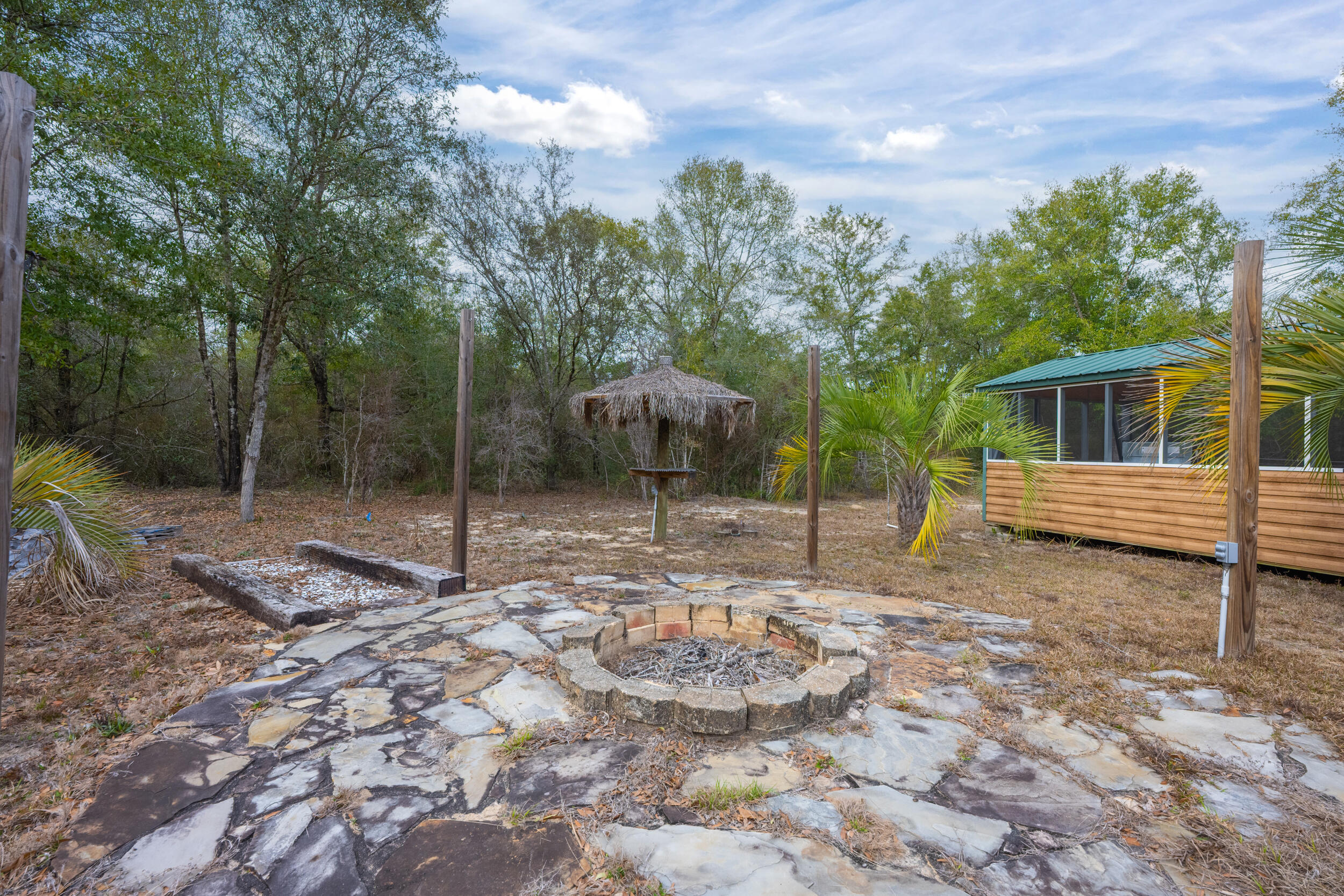 4528 Bryant Bridge Cutoff Road Holt, FL 32564 - Photo 57 of 63 a backyard of a house with lots of green space