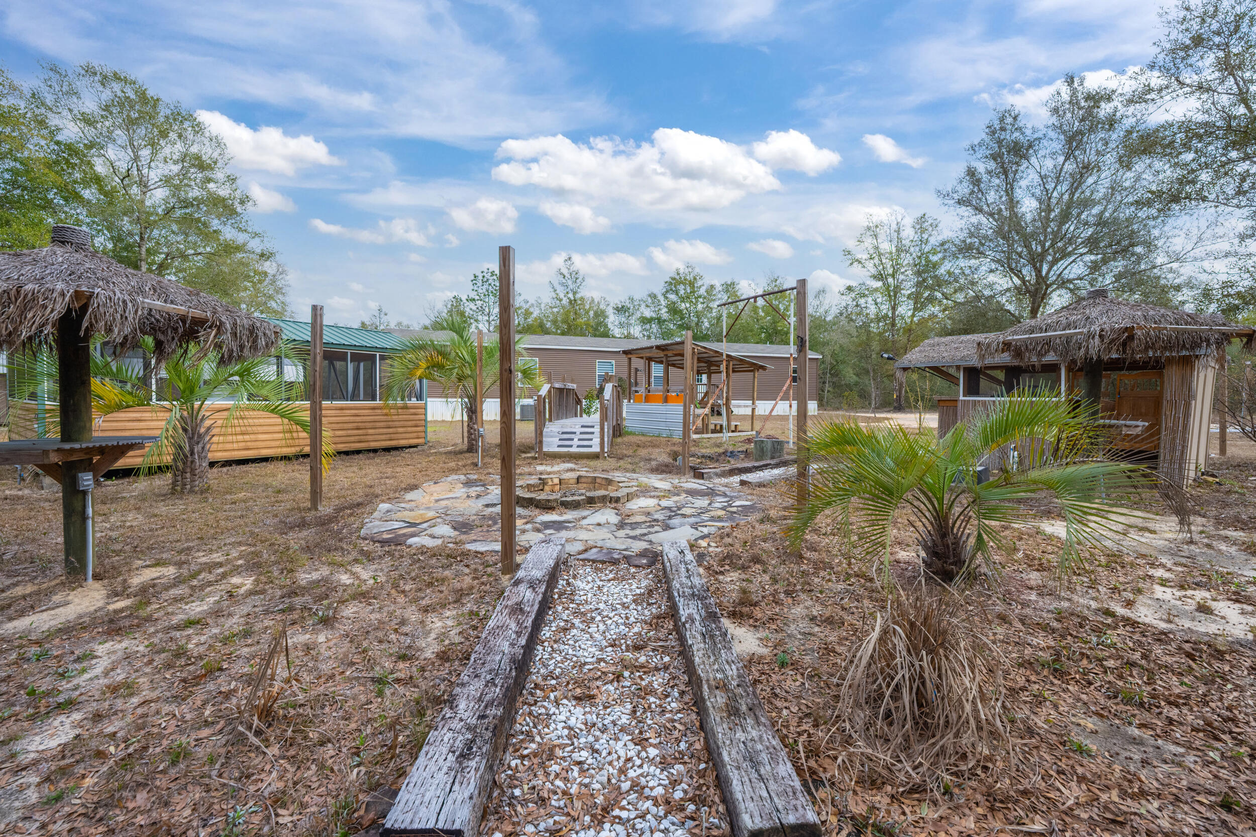 4528 Bryant Bridge Cutoff Road Holt, FL 32564 - Photo 58 of 63 a view of a house with backyard porch and sitting area