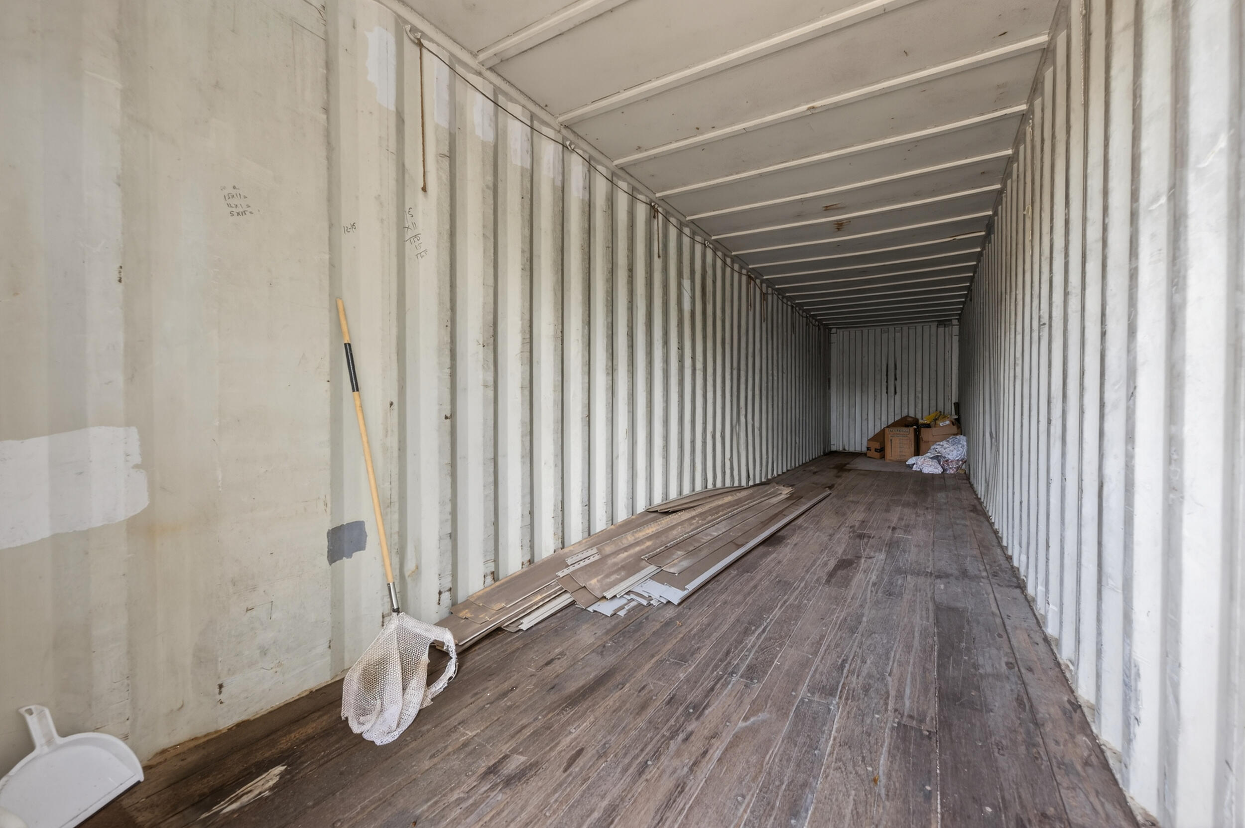 4528 Bryant Bridge Cutoff Road Holt, FL 32564 - Photo 60 of 63 a view of a hallway with wooden floor and furniture