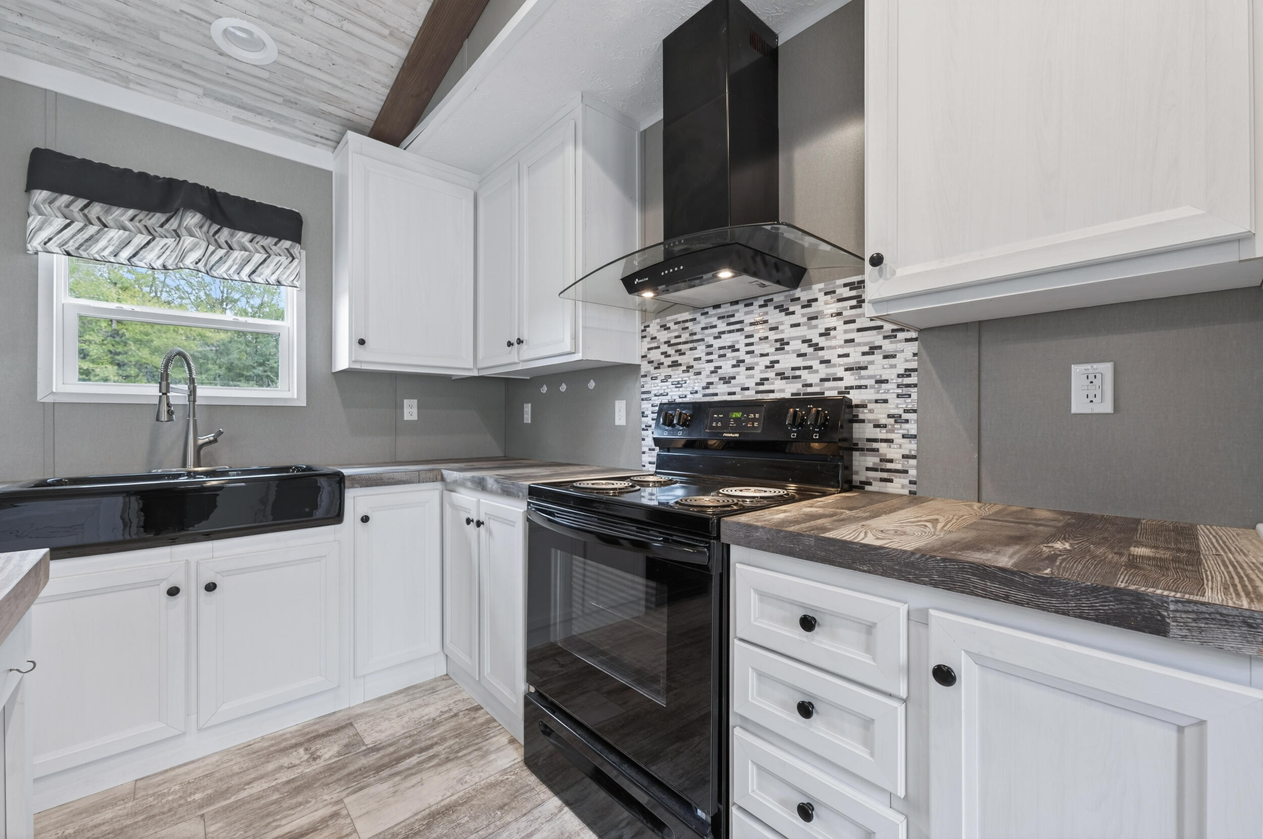 4528 Bryant Bridge Cutoff Road Holt, FL 32564 - Photo 10 of 63 a kitchen with granite countertop a stove sink and cabinets