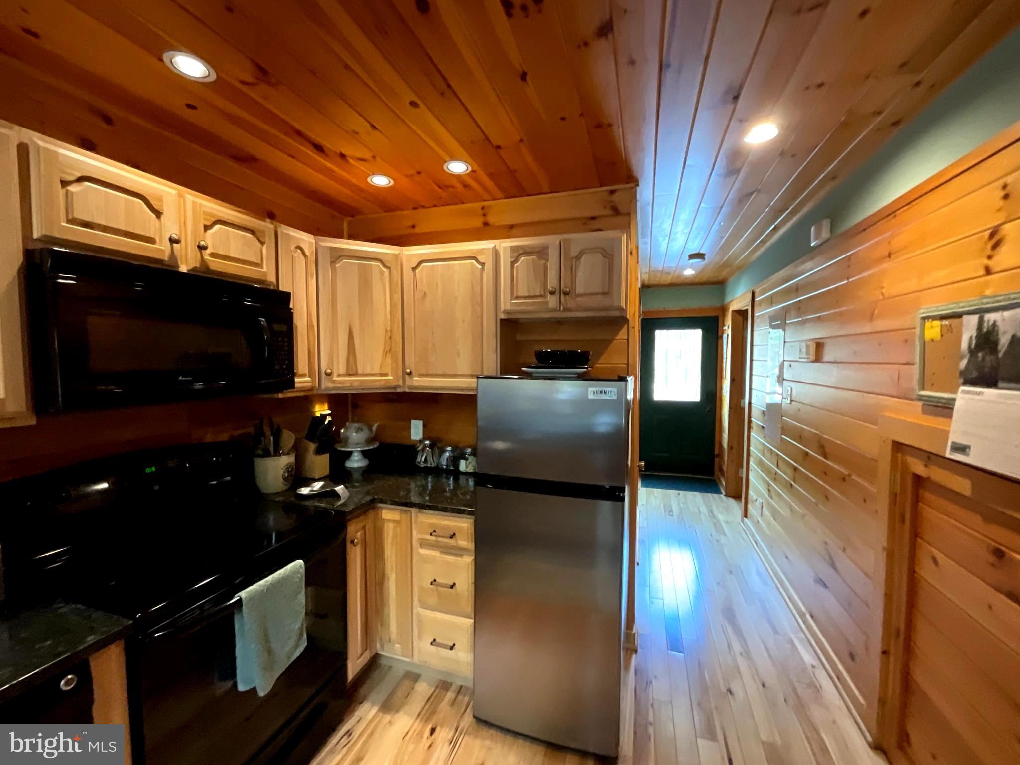 4839 Graces Cabin Road Romney, WV 26757 - Photo 5 of 26 a kitchen with stainless steel appliances granite countertop a stove a sink and a microwave