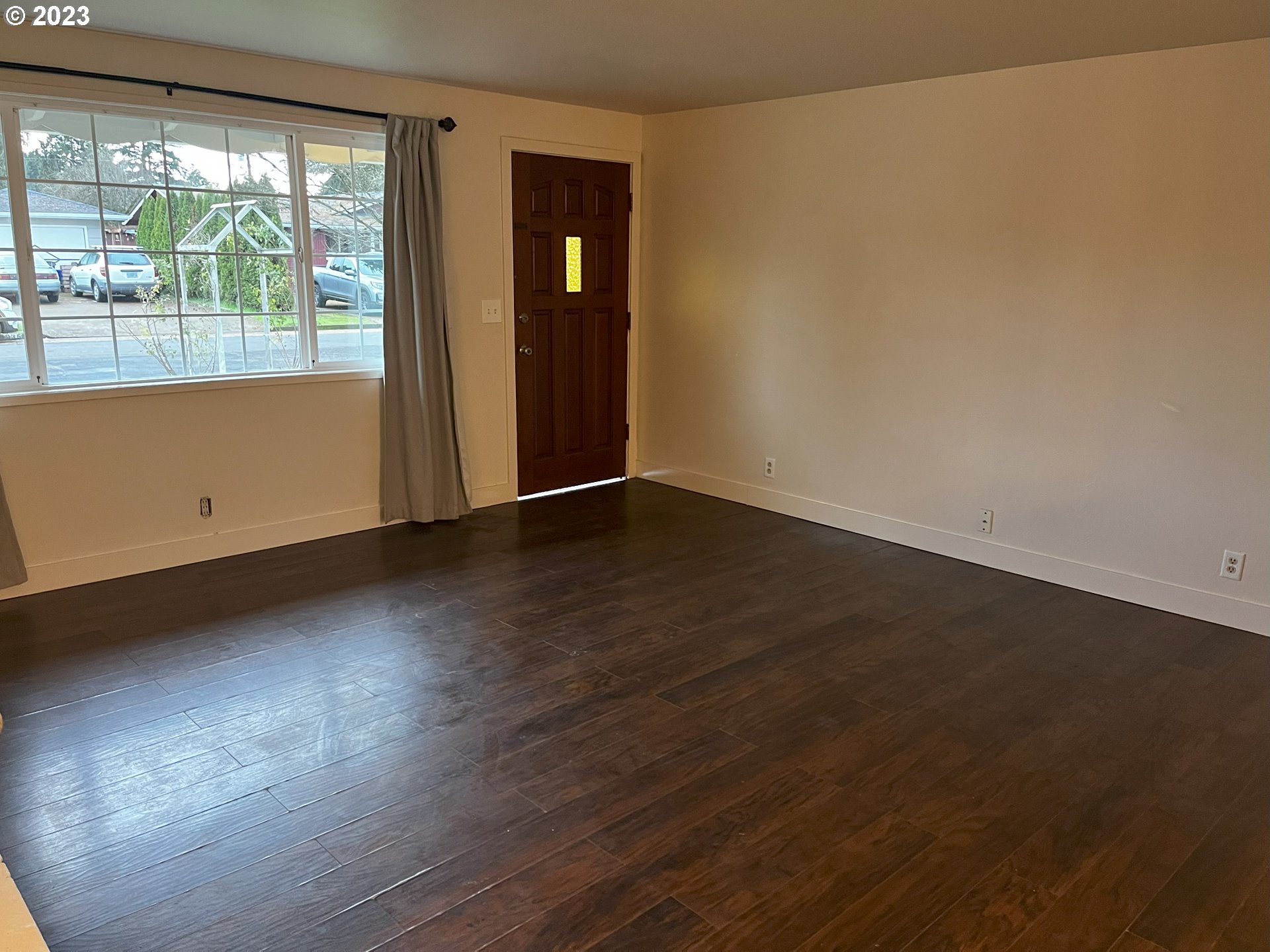 934 Olympic Street Springfield, OR 97477 - Photo 3 of 26 an empty room with wooden floor and windows