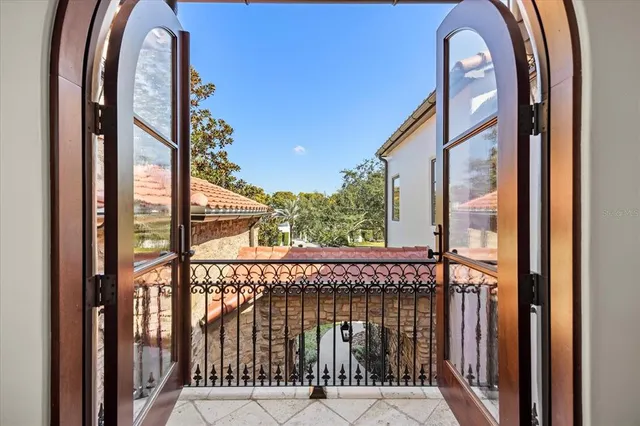 an aerial view of residential houses with outdoor space and trees