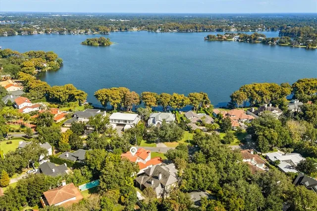 an aerial view of a house with swimming pool and outdoor space