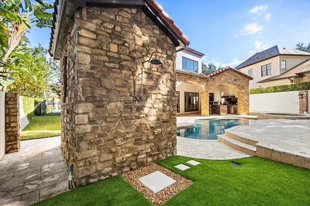 a dining room with chandelier and wooden floor