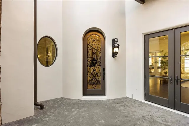 a bedroom with a large bed and a chandelier