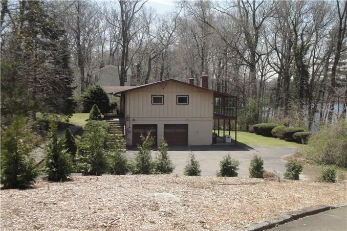 139 Canoe Brook Road Trumbull, CT 06611 - Photo 1 of 1 a white house that has a tree in front of it