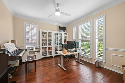 a workspace with wooden floor and a window