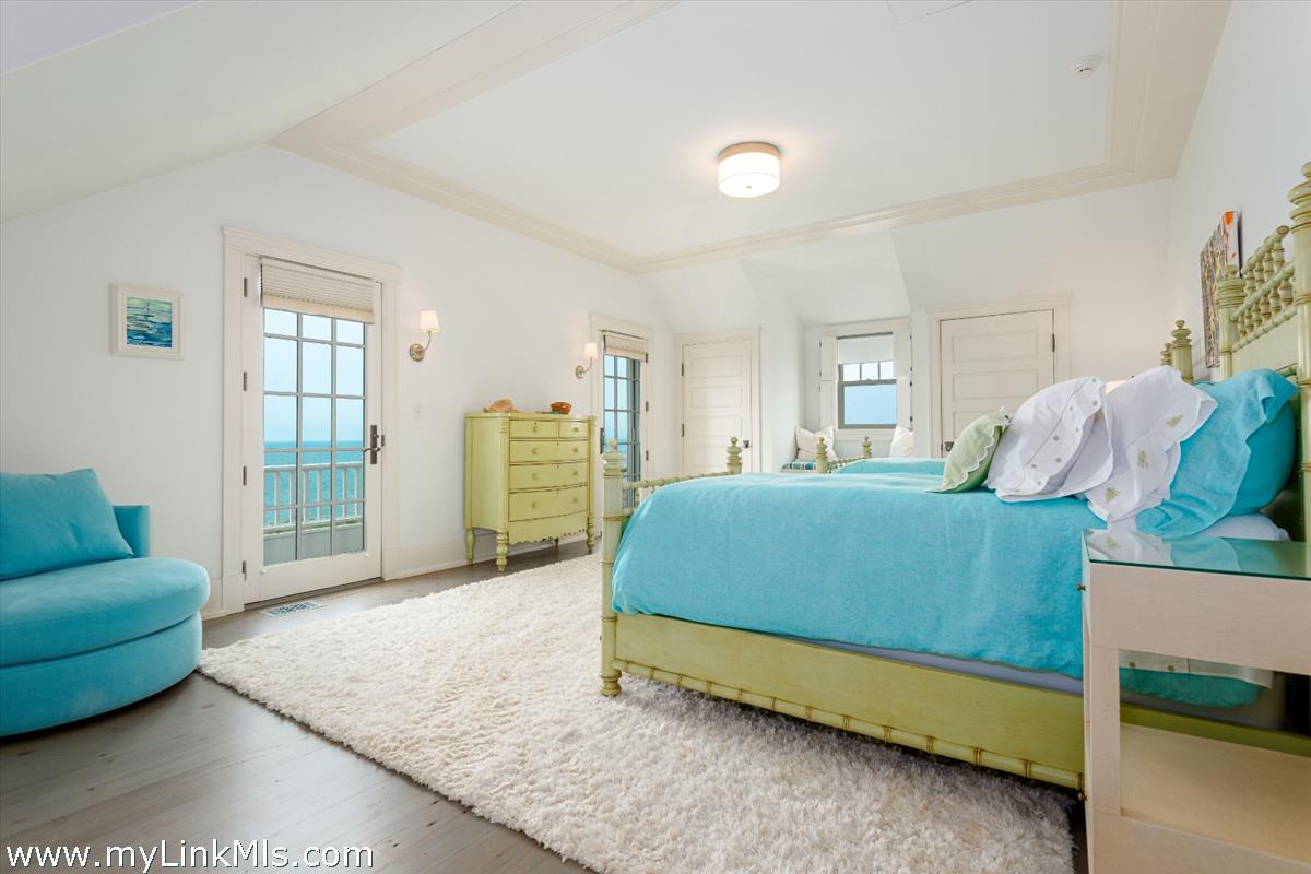 37 Sankaty Head Road Nantucket, MA 02554 - Photo 34 of 65 a bedroom with a bed a couch and a dresser with wooden floor