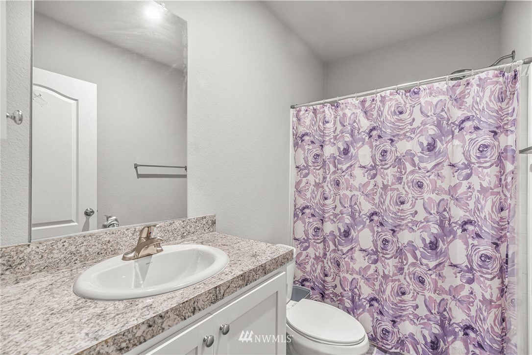 40822 Dorman Road Gold Bar, WA 98251 - Photo 17 of 34 a bathroom with a granite countertop sink a toilet and a mirror