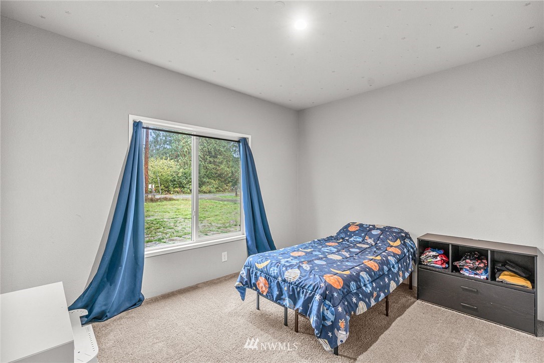 40822 Dorman Road Gold Bar, WA 98251 - Photo 18 of 34 a bed sitting in a bedroom next to a window