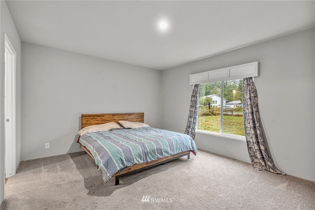 40822 Dorman Road Gold Bar, WA 98251 - Photo 21 of 34 a bedroom with a bed and a window